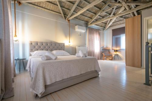 a bedroom with a large bed in a room at Traditional Stone House in Thános