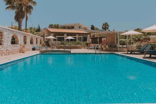 a large swimming pool with blue water at Creta Vitalis in Kalathas