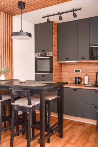 a kitchen with a large wooden table and chairs at All Seasons Residence in Zlatibor