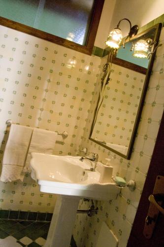 a bathroom with a sink and a mirror at Residence Il Convento in SantʼAngelo a Fasanella