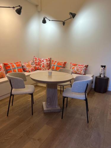 a room with a table and chairs and a couch at Domaine de Panery in Pouzilhac