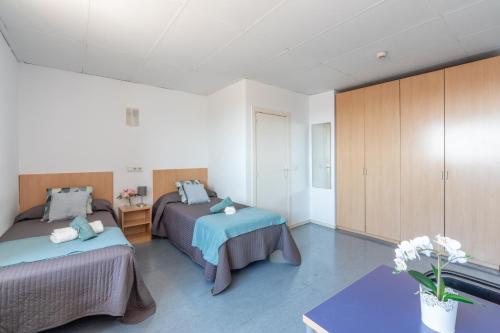 Postel nebo postele na pokoji v ubytování Residencia Universitaria Resa Lesseps