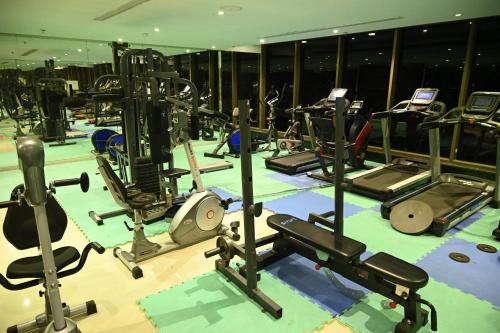 a gym with lots of exercise equipment on the floor at Aster Hotel in Jeddah