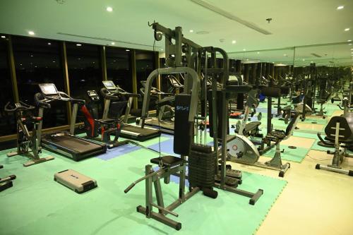 a gym with a bunch of treadms and machines at Aster Hotel in Jeddah