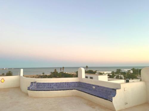 a view of the beach from the balcony of a house at Villa Fadila in Sidi Mansour