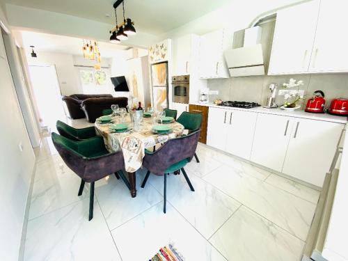 a kitchen with a table and chairs in a room at Exclusive Villa Larnaca - 8 plus sleeps - 2 min from BEACH - Big Private Pool in Pyla