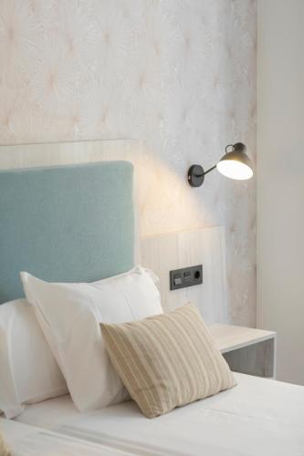 a bedroom with a bed with a lamp and a pillow at Soho Boutique Bahía Málaga in Málaga