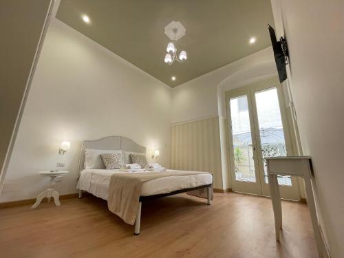 a bedroom with a large bed and a window at Domus Bianca Lancia in Manfredonia