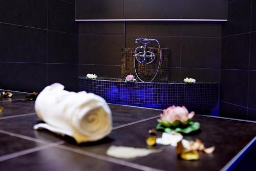a bathroom with a sink and a shower in a room at Garden Spa Boutique Hotel in Skopje