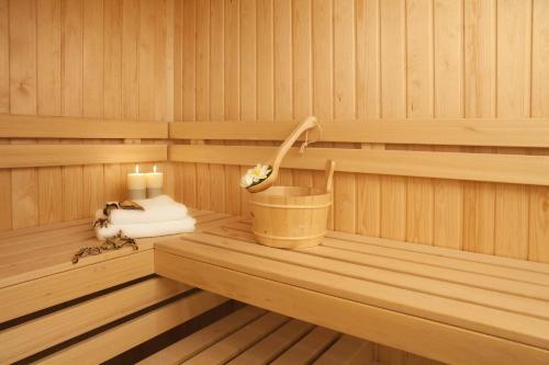 a inside of a sauna with a candle and towels at Garden Spa Boutique Hotel in Skopje
