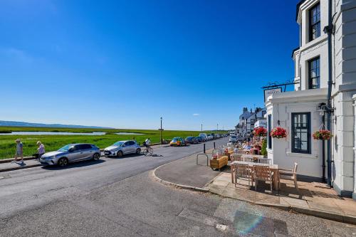 a street with cars parked on the side of a road at The Ship in Parkgate