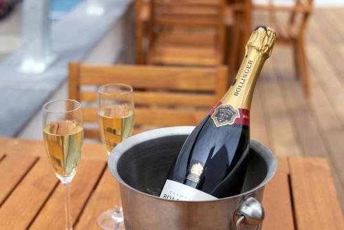 a bottle of champagne in a bucket on a table with two glasses at The Ship in Parkgate