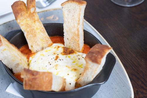 a bowl of food with bread and bread sticks at The Ship in Parkgate