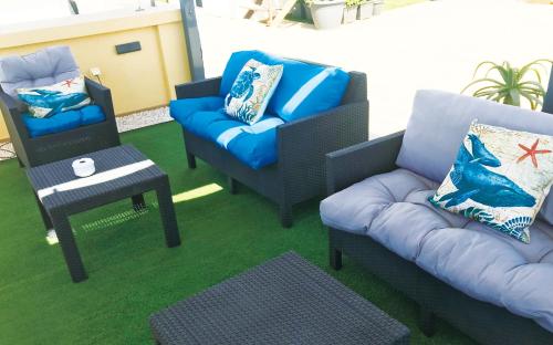 a living room with two chairs and a couch and a table at Hotel Costasol in Almería