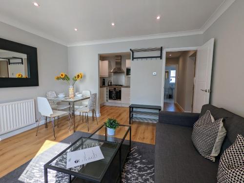 a living room with a couch and a table at Saffron Court by Wycombe Apartments - Apt 08 in High Wycombe