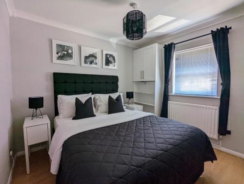 a bedroom with a large bed and a window at Saffron Court by Wycombe Apartments - Apt 08 in High Wycombe