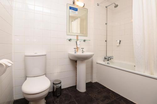 a bathroom with a toilet and a sink and a tub at White Hart, Exeter by Marston's Inns in Exeter