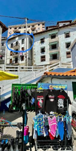 a group of shirts on display in front of a building at Precioso apartamento en el puerto de Elantxobe in Elanchove