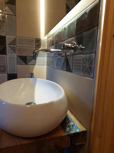 a bathroom with a white sink on a counter at The Cocoon and olives Hut in Koropi