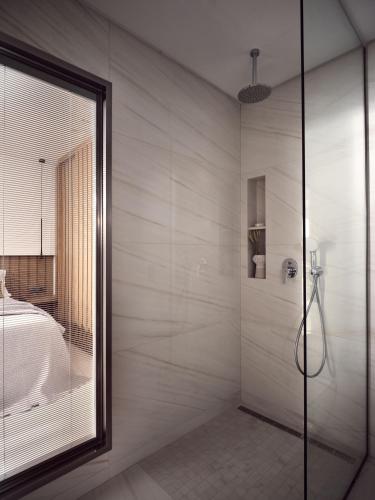 a bathroom with a shower with a glass door at Anthis Luxury Villas - A Haven of Serene Modern Elegance, by ZanteWize in Zakynthos Town