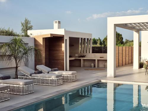 a villa with a swimming pool and a patio at Anthis Luxury Villas - A Haven of Serene Modern Elegance, by ZanteWize in Zakynthos Town
