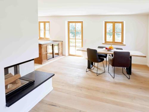 a kitchen and dining room with a table and chairs at Natur pur - Doppelhaushälfte im idyllischen Kreuth in Kreuth