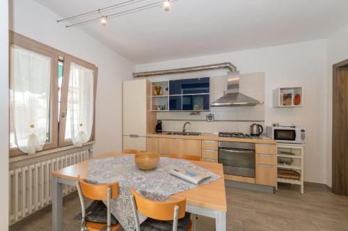 a kitchen with a wooden table and a table and chairs at Casacobelli in Monzambano