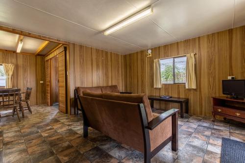 a living room with a couch and a television at Lazy Days Caravan Park in Vasse