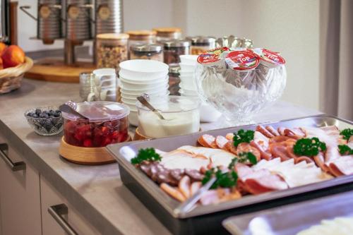 a counter with a tray of food on a table at REGIOHOTEL Wolmirstedter Hof Wolmirstedt in Wolmirstedt