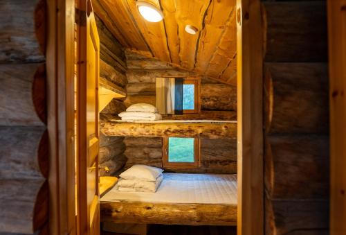 a room in a log cabin with a bed in it at Arctic Log Cabins in Saariselka