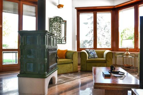 a living room with a couch and a fireplace at Villa Sequoia in Leinì