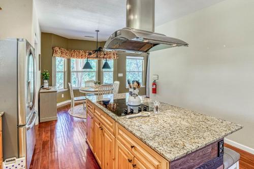 a kitchen with a counter top and a stove top oven at Wooded Bliss in Mariposa