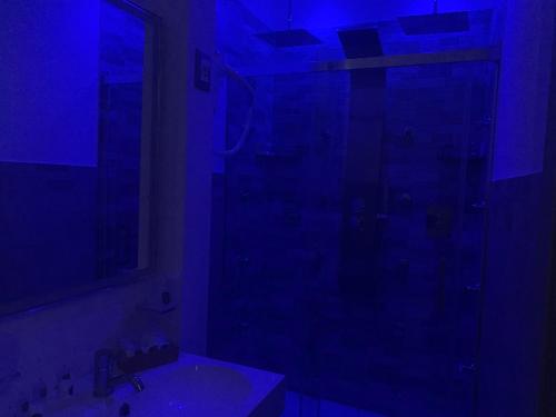 a dark bathroom with a shower and a sink at B&B D'Amari Affittacamere in Palermo