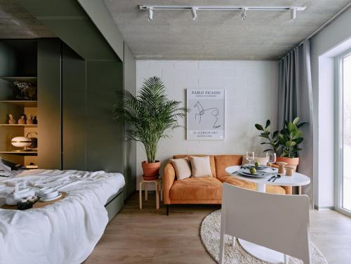 a bedroom with a bed and a couch and a table at Campus House by Larsen in Tallinn