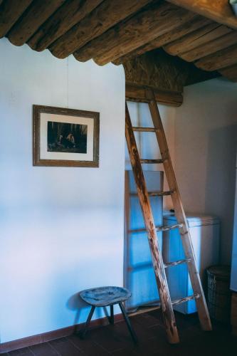 a ladder and a stool in a room at Casa de Vacanta Colibita Veche- pe malul lacului in Colibiţa