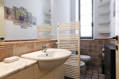 a bathroom with a sink and a toilet at Charming San Babila Apt. in Milan