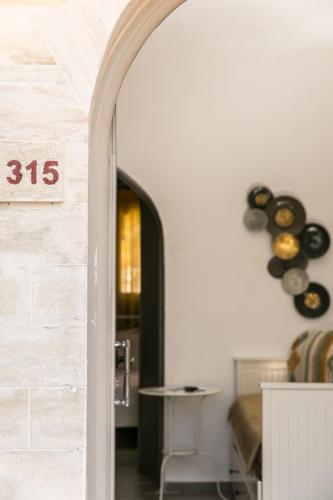 an archway leading into a dining room with vases on the wall at Creta Vitalis in Kalathas