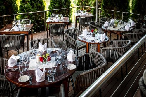 a group of tables and chairs on a deck at Landidyll-Hotel Nudelbacher in Feldkirchen in Kärnten