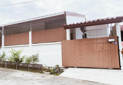 a house with a wooden fence in front of it at Sundae Haus in Betong