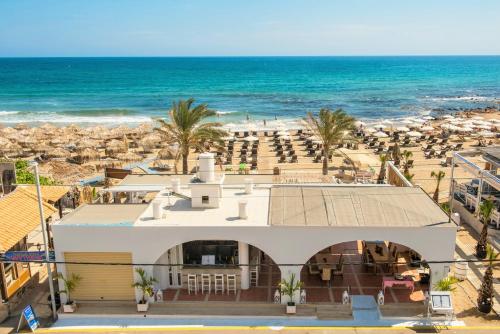 an aerial view of a resort with the beach at Smaragdine Beach Hotel in Stalís