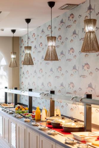 a buffet line with many plates of food at Soho Boutique Puerto in El Puerto de Santa María