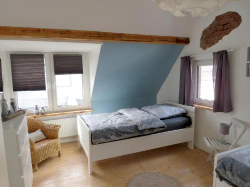 a bedroom with a bed and a blue wall at Gut Brüggen in Kerpen