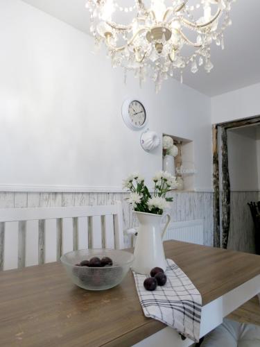 a dining room table with a chandelier and a vase at Gut Brüggen in Kerpen