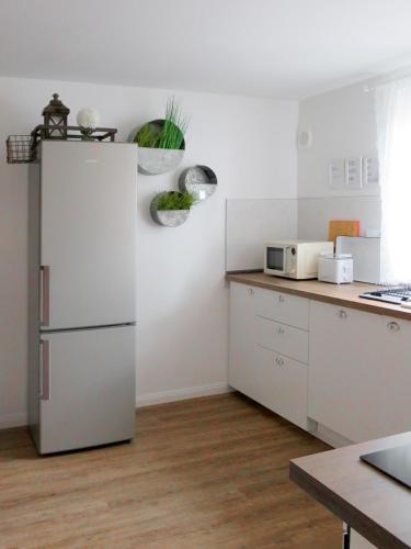a kitchen with a white refrigerator in a room at Gut Brüggen in Kerpen