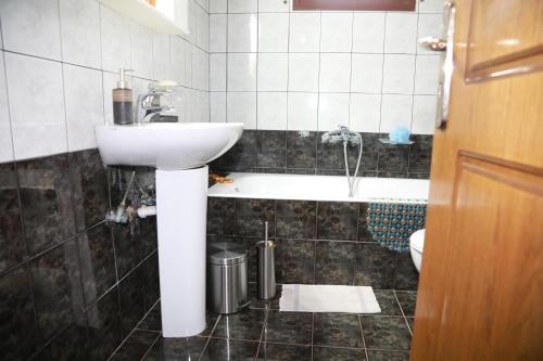 a bathroom with a sink and a bath tub at Lemon tree house in Kalloni