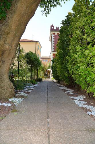 a sidewalk with a tree on the side of it at Villa Angelica in Venice-Lido