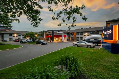 a parking lot in front of a building with cars parked at Comfort Inn West in Ottawa