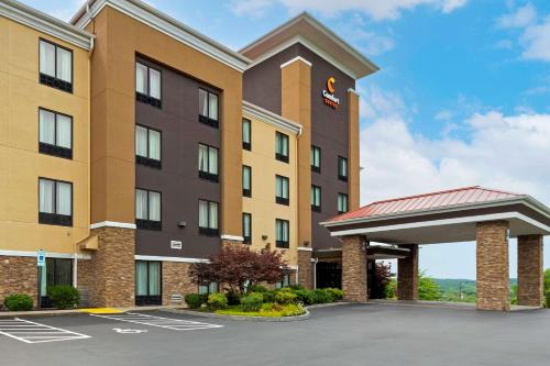 a large building with a clock on the front of it at Comfort Suites Kingsport in Kingsport