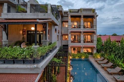 an exterior view of a house with a swimming pool at Grange in Siem Reap