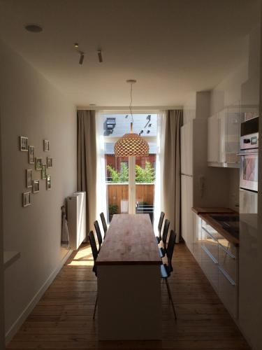 a dining room with a table and chairs in a kitchen at Gîte de Lombard in Ypres